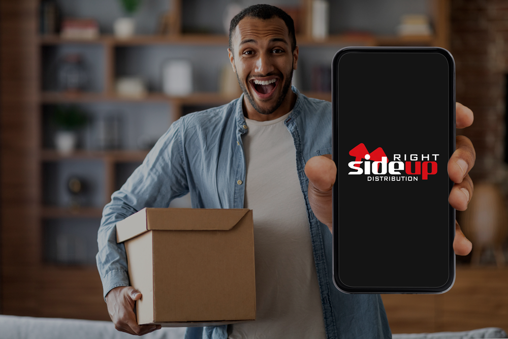 delivery-service-app-excited-black-man-holding-box-showing-blank-smartphone